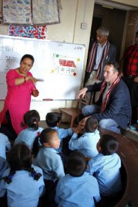 Honorable Peter Budd interacting with teacher and students