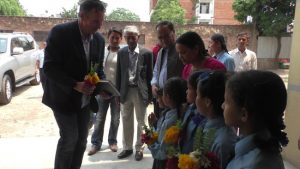 Honorable Peter Budd, Ambassador of Australia receiving bunch of flower from panchakanya at school premises