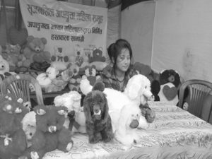 A woman with physical disability who is selling handicrafts