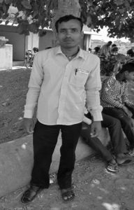 A man who have physical disability standing in the front of tree