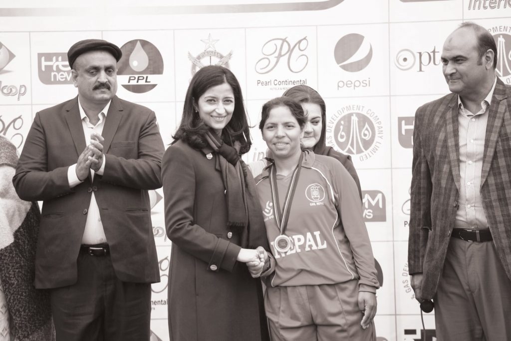 a student in a wheelchair is being helped by her friend in her school