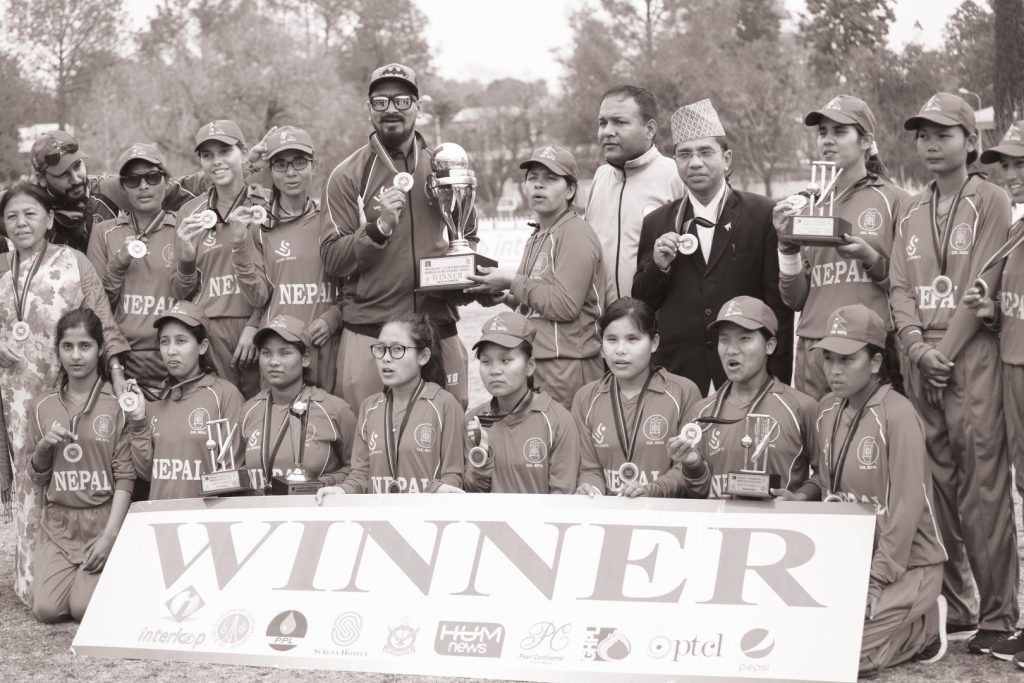The group photo of Nepali team after they won the tournament. They are seen with trophy and winner banner