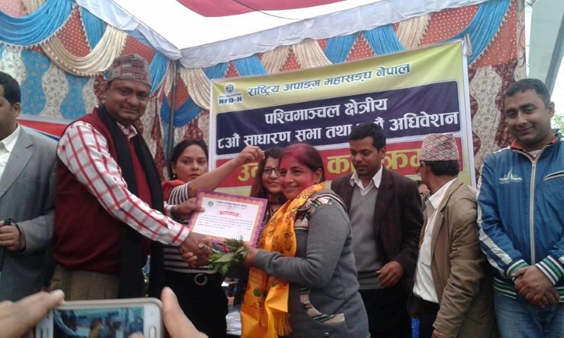 NFDN president giving certificate of winning to Newly elected regional president Ms. Kalpana Dhakal