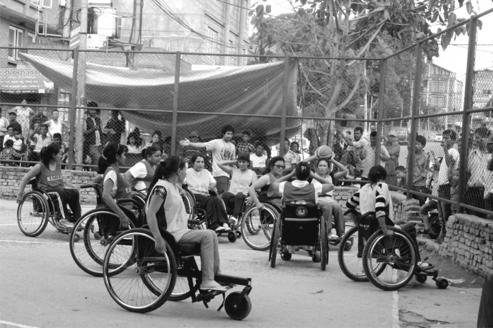 women using wheelchairs playing basket ball