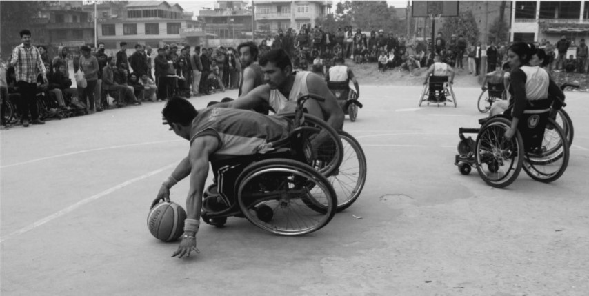 Men using wheelchair playing Basketball