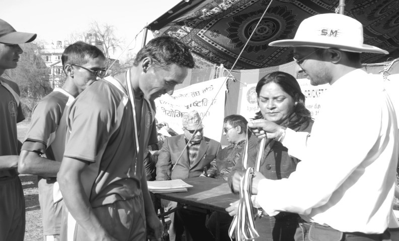 A blind cricket player getting medal