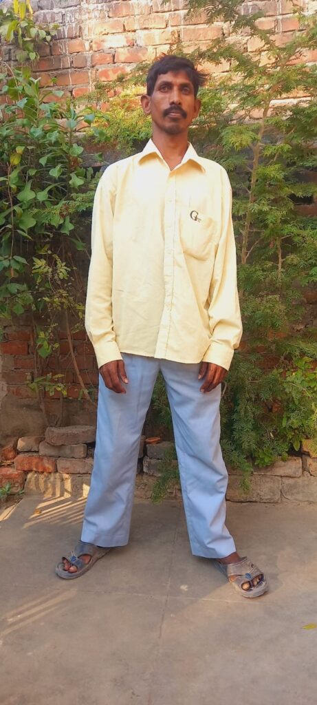 Man standing and wearing yellow shirt and blue pant