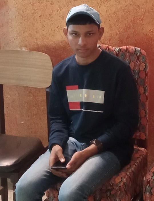 Boy seating on chair and holding mobile