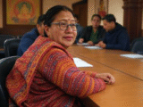 Close up shot of a women sitting in a meeting table